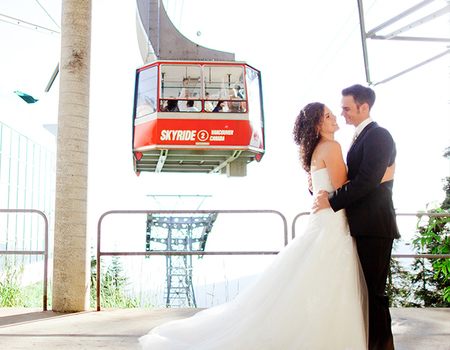 Couple on wedding day in front of Grouse Mountain's red Skyride
