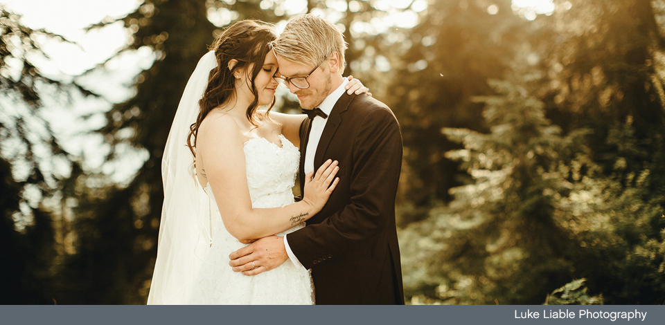 Married couple with Grouse Mountain's wilderness in the background