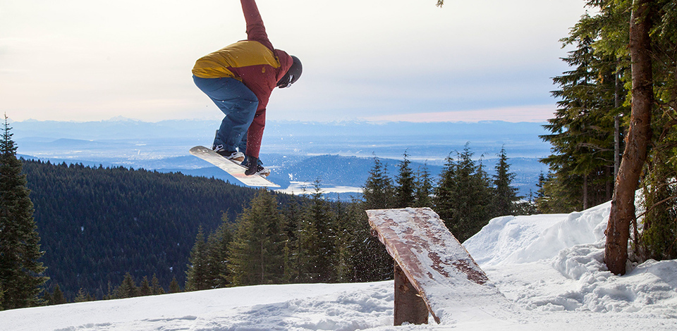 Snowboarder jumping in Grouse Woods™